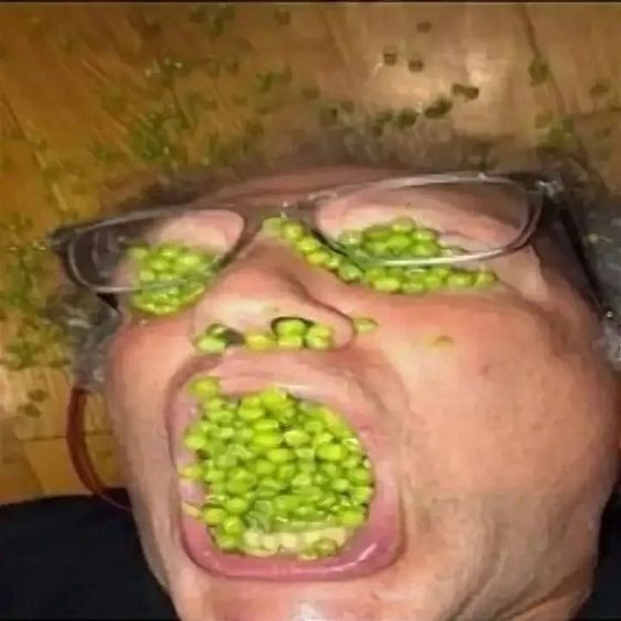 guy with glasses that has his mouth and eyes and nose filled with peas